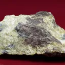 Althausite (type locality) with Hematite and Lizardite - image 1