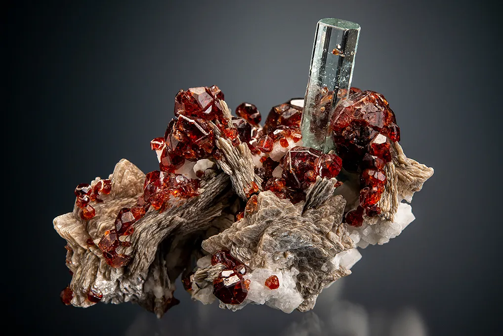 Beryl var. Aquamarine with Spessartine on Muscovite image