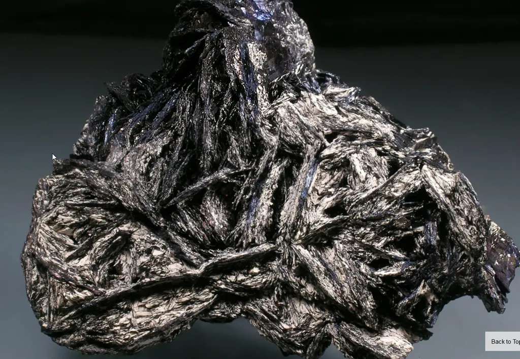 Covellite grouping with white unknown mineral dusting image