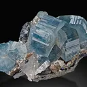 Fluorapatite, gemmy, pale blue crystals on Calcite - image 2