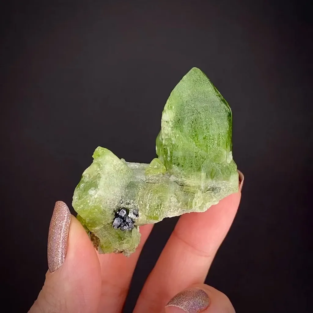 Forsterite var. Peridot with Magnetite image