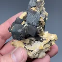 Goethite after Siderite with Hematite, Schorl, Microcline - image 2