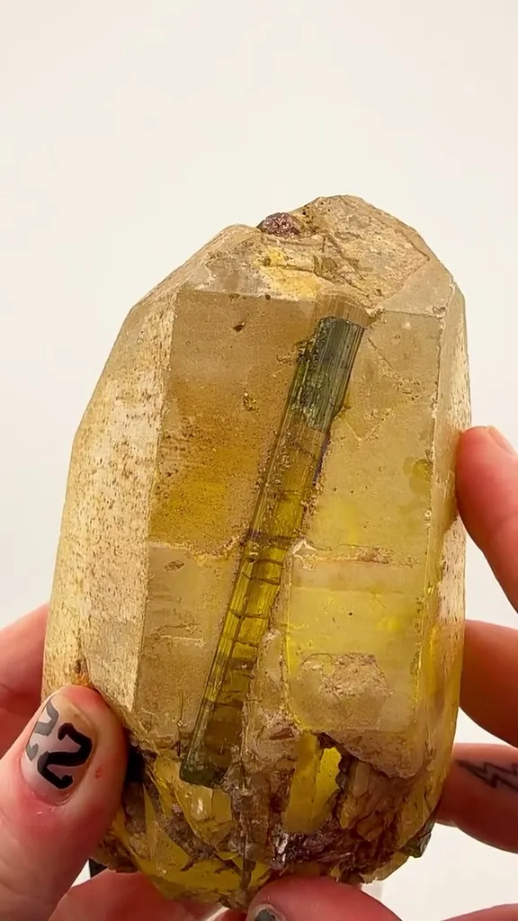 Golden crystal, Emerald-green Tourmaline, and millions of years of geological perfection. image