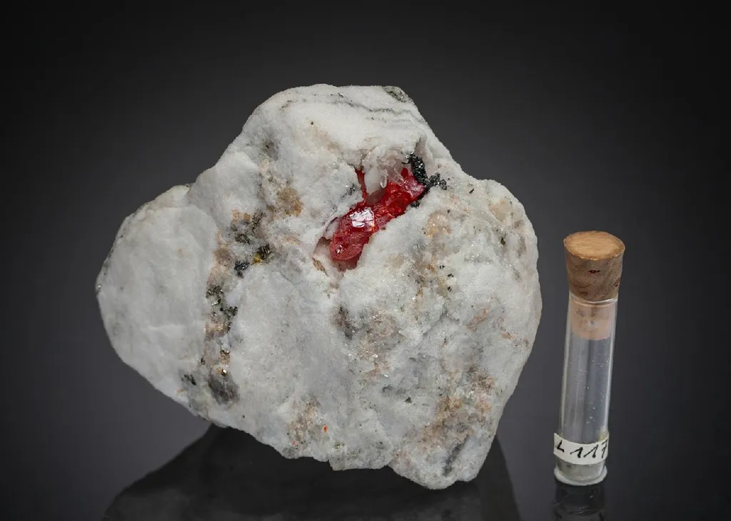 LENGENBACHITE with Realgar phial and hand specimen image