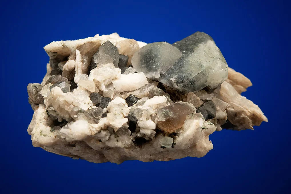 Phenakite on Quartz var. Smoky and Calcite - image 3