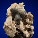 Phenakite on Quartz var. Smoky and Calcite - image 1