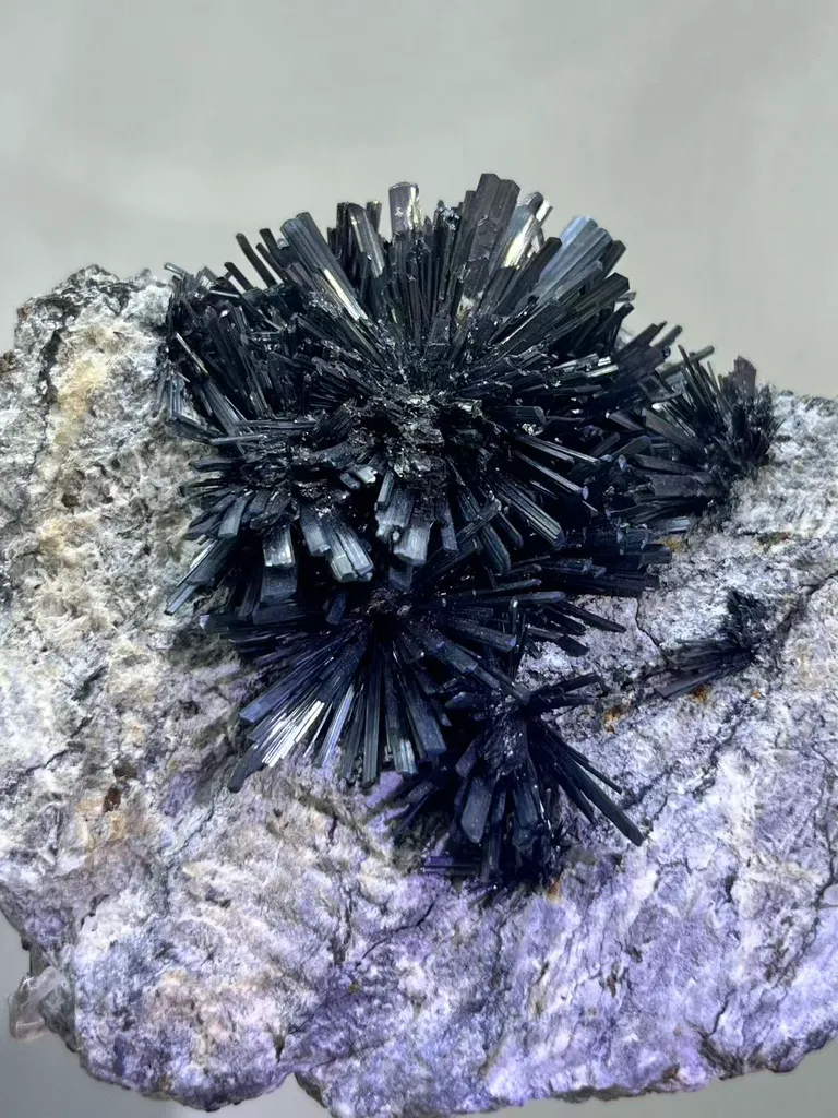 Radiant Spray‑Shaped Stibnite Cluster on Purple Fluorite Matrix, Xikuangshan Mine, Hunan, China - image 2