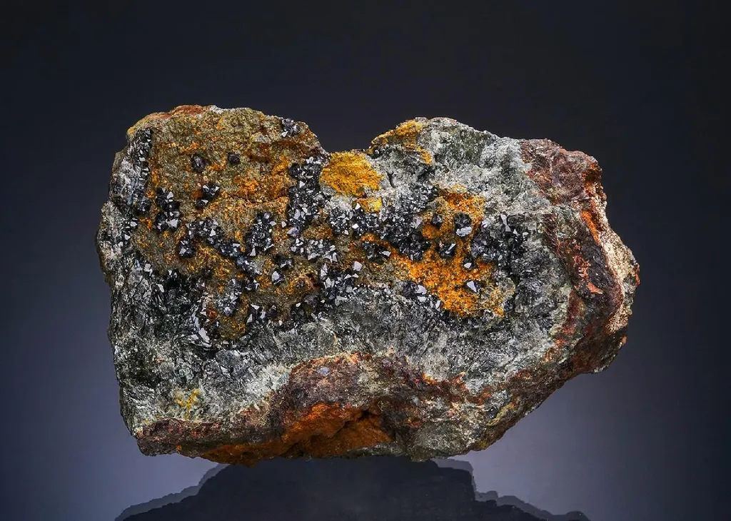 Scorodite with Karibibite on Lollingite image