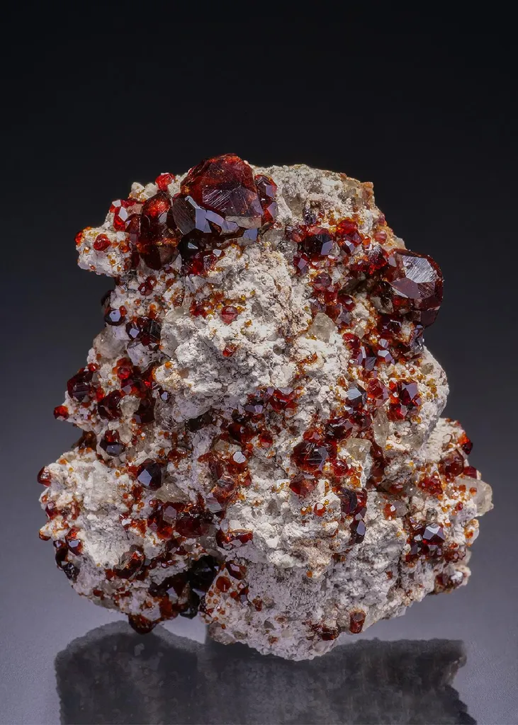 Spessartine on Feldspar with Quartz image