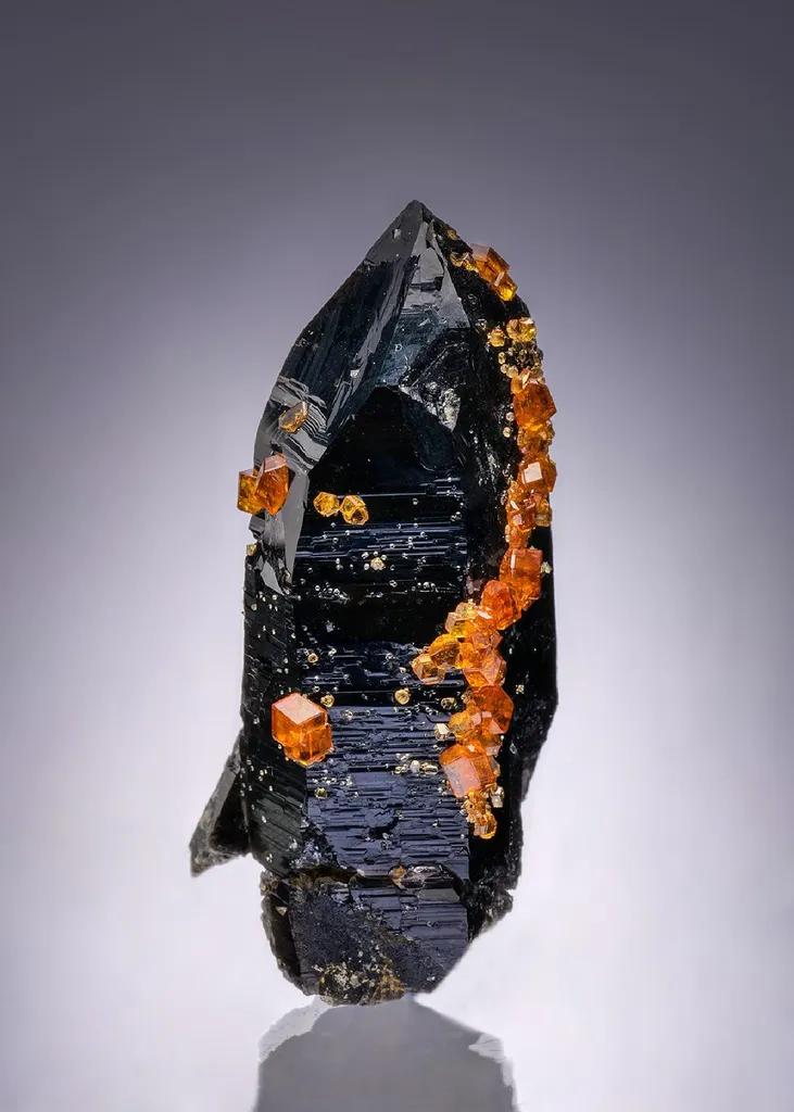 Spessartine on Smoky Quartz image