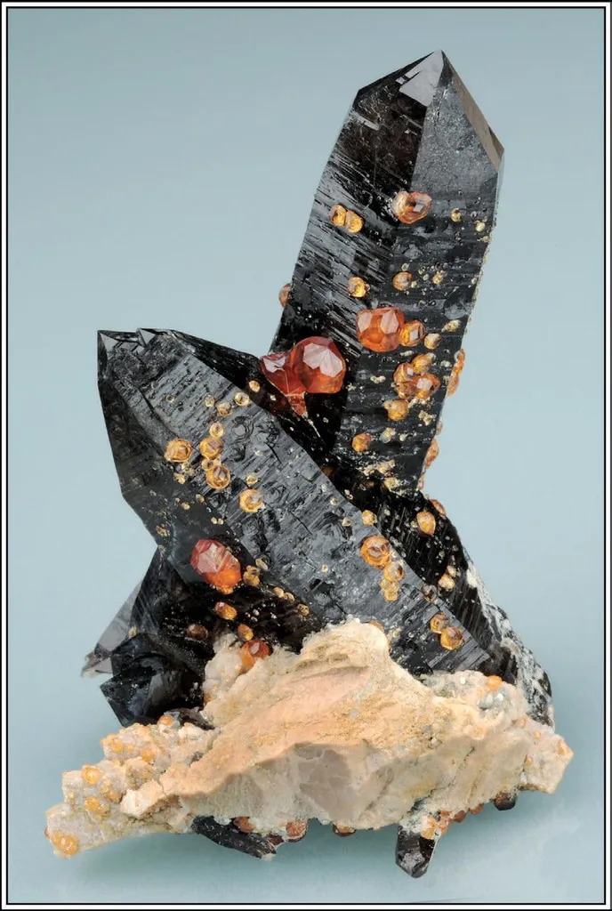 Spessartine on Smoky Quartz image