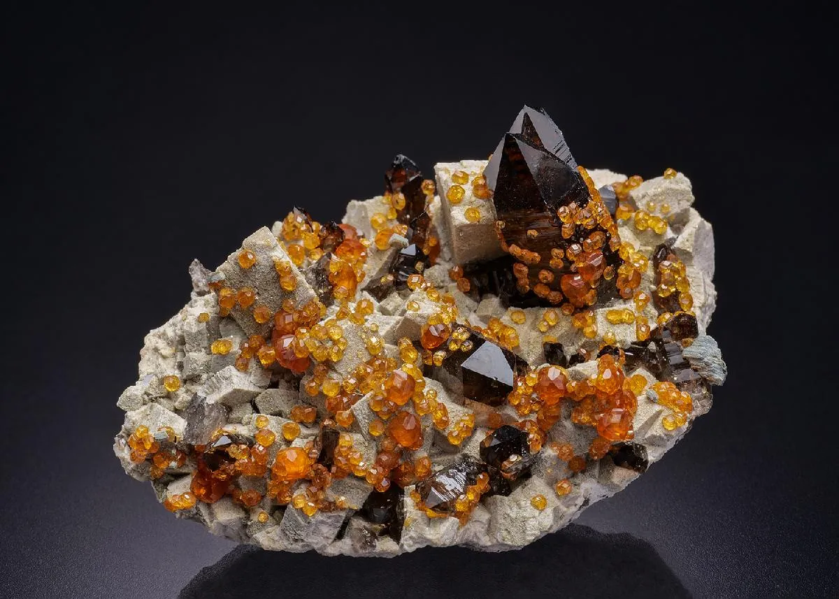 Spessartine on Smoky Quartz on Microcline - image 1