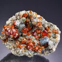 Spessartine with Fluorite on Muscovite and Microcline - image 1