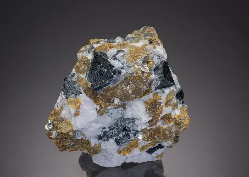 Spinel with Chondrodite and Muscovite in Calcite