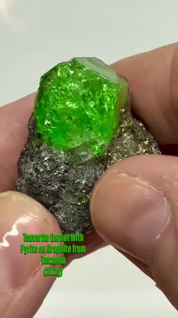 Tsavorite Garnet with Pyrite on Graphite from Tanzania image