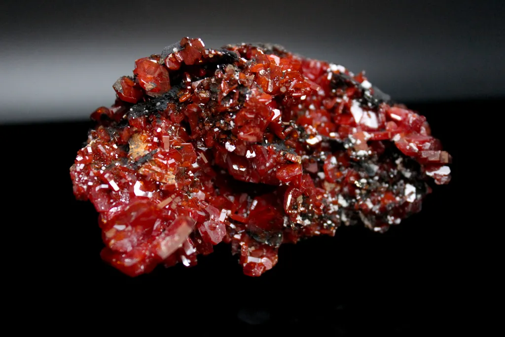 Vanadanite Crystals on black (manganese?) host rock image